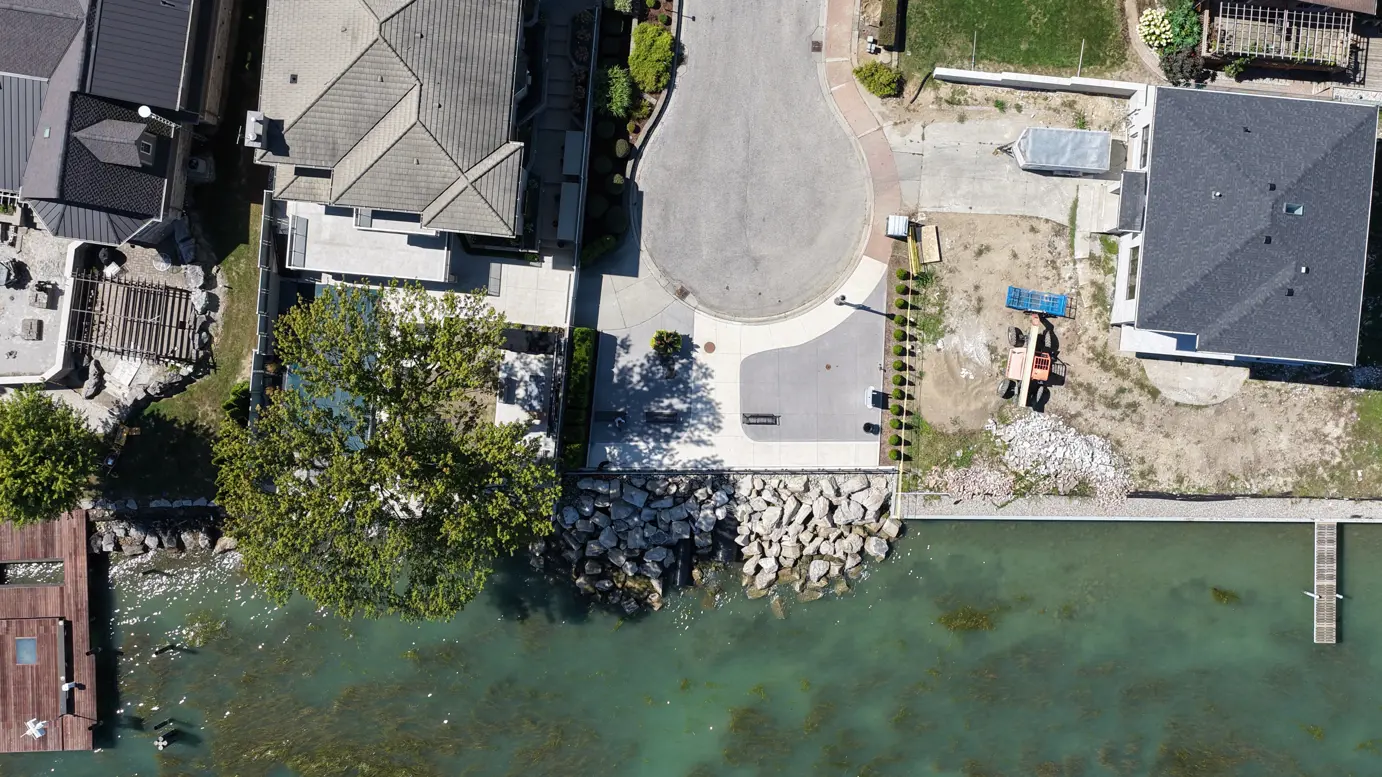 Aerial of Alma parkette showing concrete, pathway and waterfront with rock revetment.