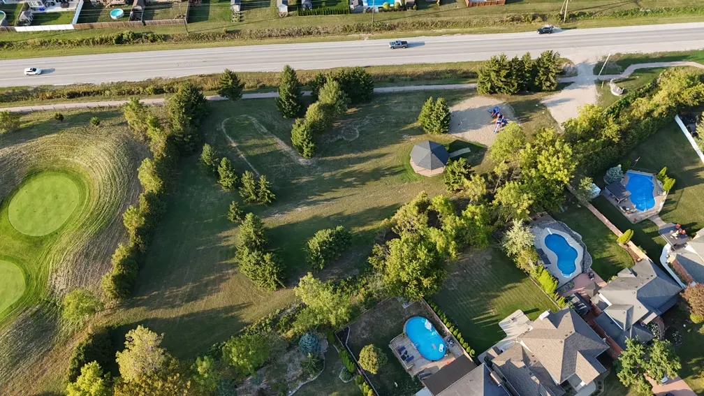 Aerial view of park showing pavilion, playground, parking lot and greenspace. 