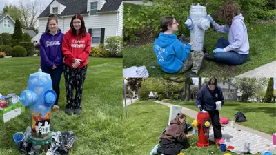 Students post with the newly painted fire hydrant murals in downtown Amherstburg. 12 murals throughout town were painted with stories of the Town's history