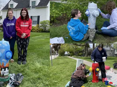 Students post with the newly painted fire hydrant murals in downtown Amherstburg. 12 murals throughout town were painted with stories of the Town's history