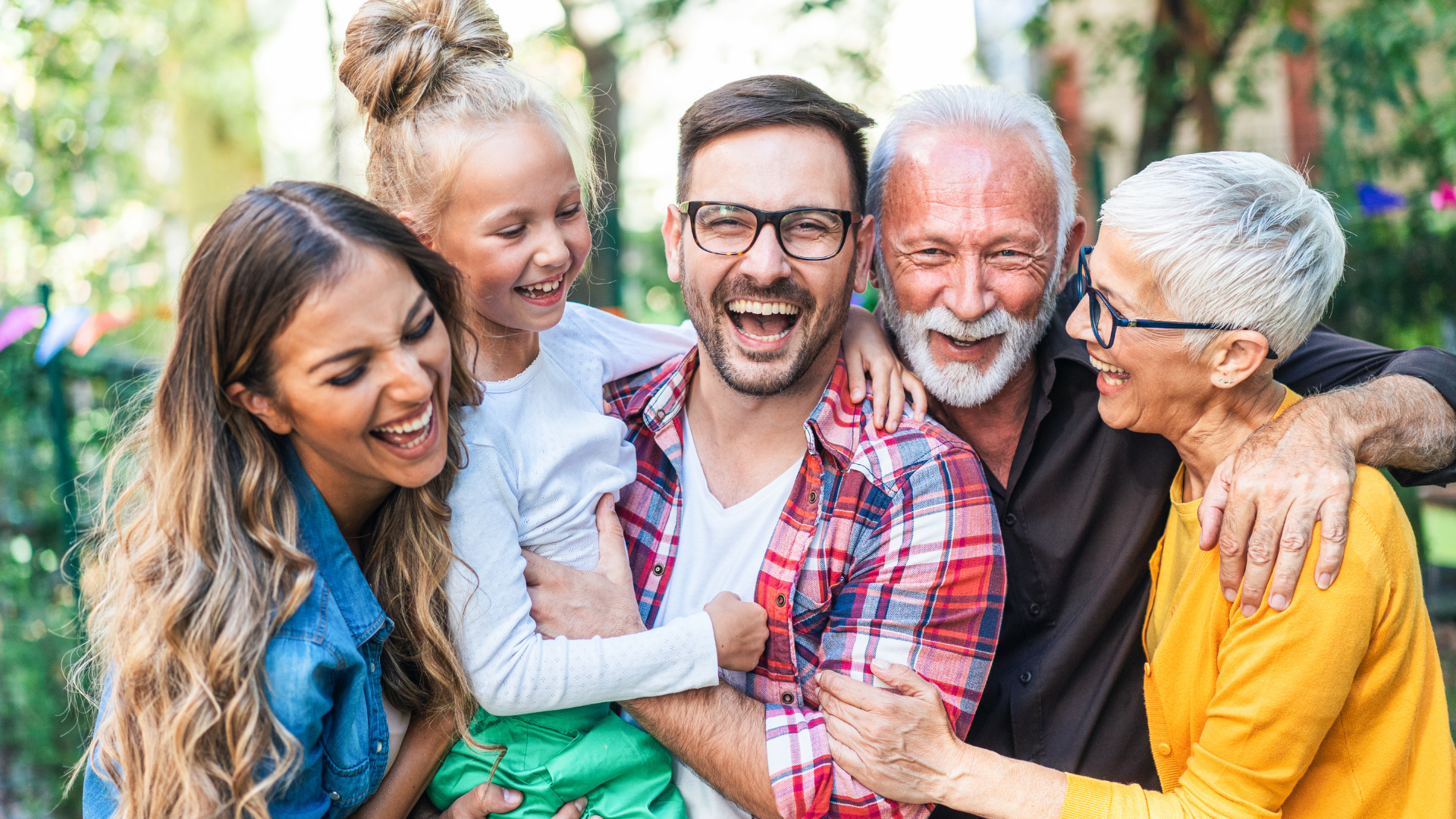 Five people laughing side-by-side for a picture
