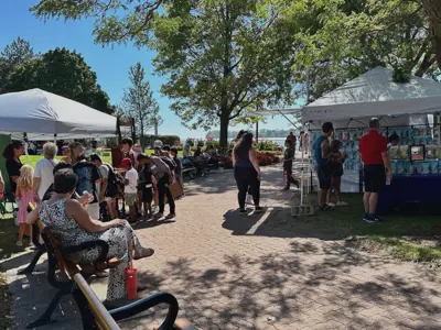 Vendor tents set up along the pathway in King's Navy Yard Park