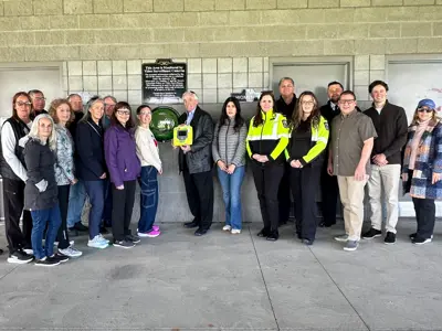 Members of Council, EMS, Fire and the community pose for a photo with the new Automated External Defibrillator located at the Libro Centre