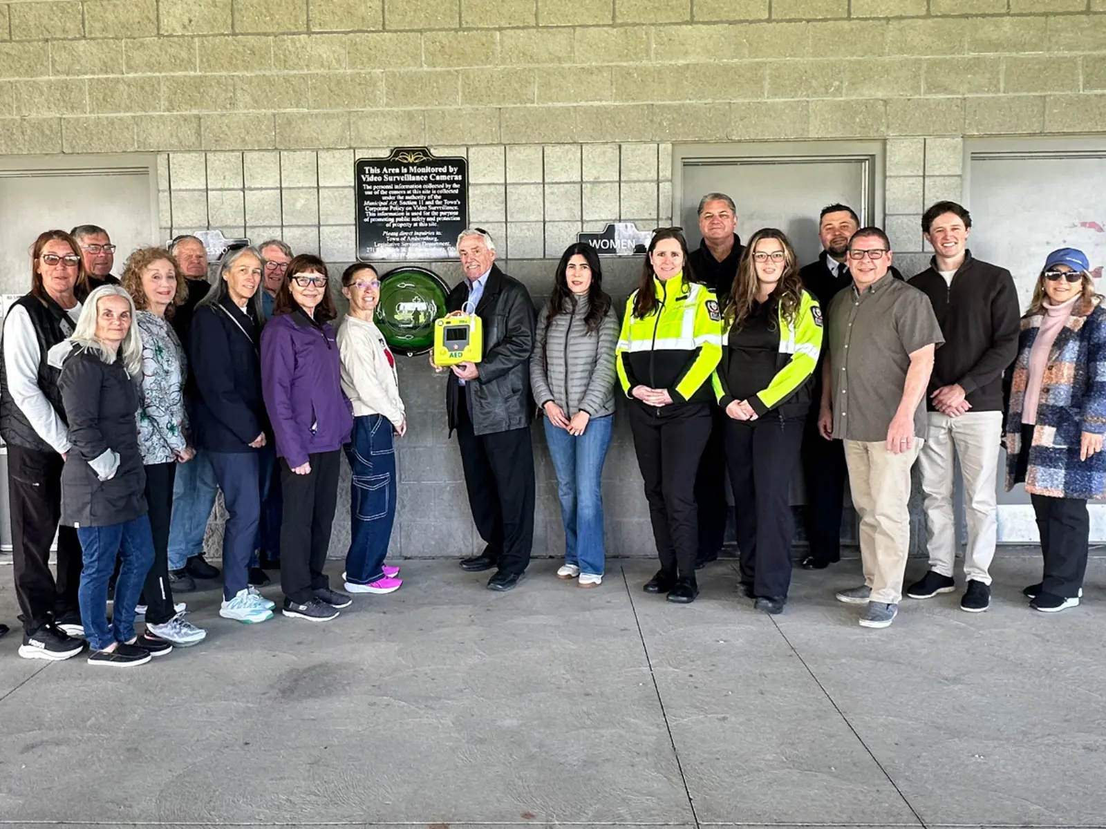 Members of Council, EMS, Fire and the community pose for a photo with the new Automated External Defibrillator located at the Libro Centre