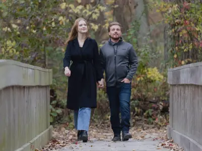 A couple walking along the boardwalk at Holiday Beach Conservation Area