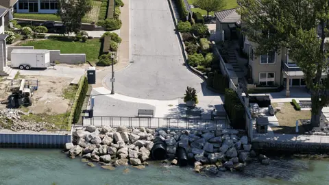 Aerial photo of parkette looking down Alma St showing waterfront with railings, pathway and benches.