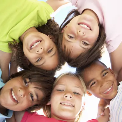 Youth in a circle showing their faces